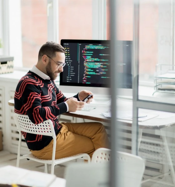 Software developer at a multi-monitor workstation